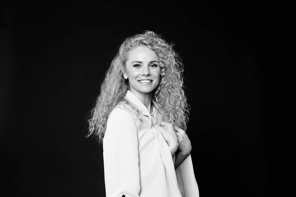 Portrait of a pretty curly blonde woman, wearing light dress and - Photo, Image