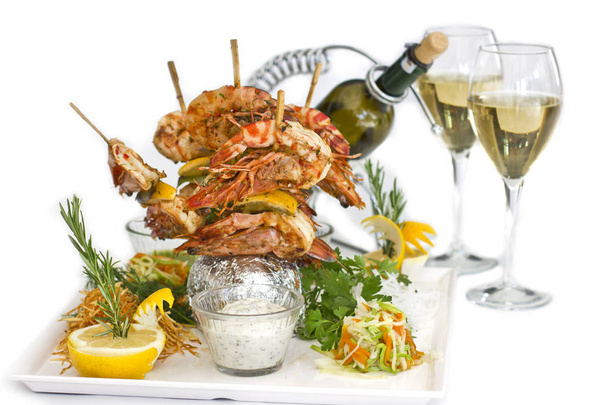 King prawns cooked on wooden skewers. Serving with sauces and he - Photo, Image