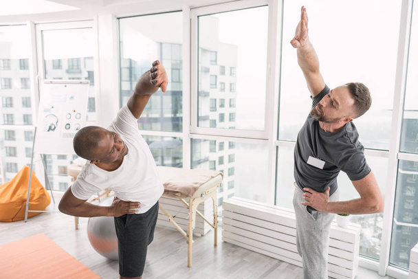 Positive active men doing gymnastics - Foto, immagini