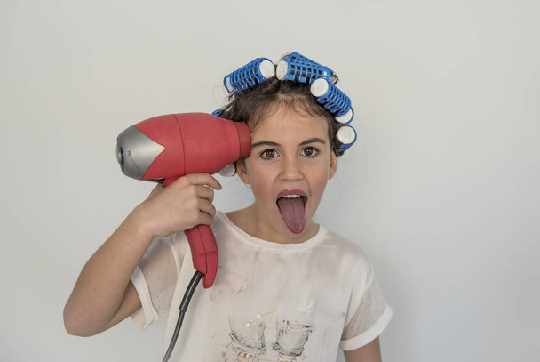 little girl posing with curlers and hair dryer - Foto, immagini