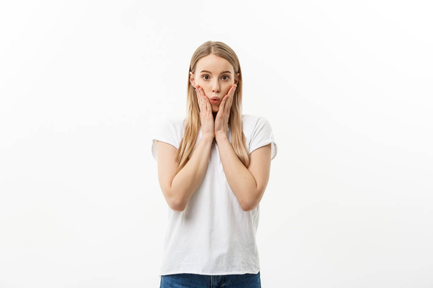 Lifestyle Concept: Portrait of a scared frightened girl standing and surprising facial expression isolated over white background. - Photo, image
