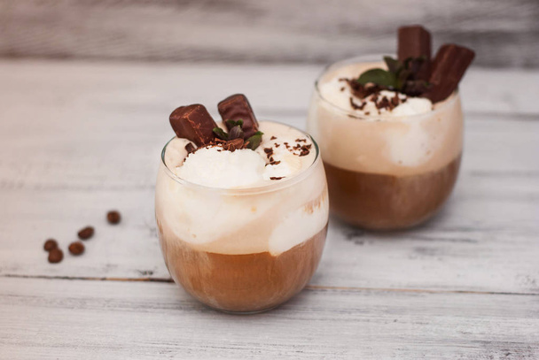 Iced Mocha Frappe Coffee with Whip Cream, Summer Drinking times. Coffee Beans. rustic textured Wooden Background. Mint Leaves - Fotoğraf, Görsel