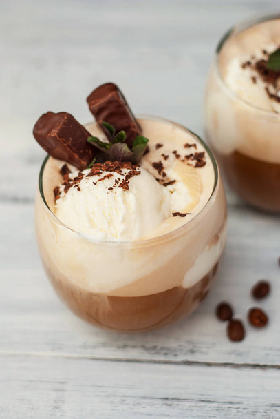 Iced Mocha Frappe Coffee with Whip Cream, Summer Drinking times. Coffee Beans. rustic textured Wooden Background. Mint Leaves - Zdjęcie, obraz