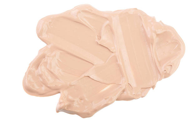 Maquillaje de base líquida beige aislado sobre fondo blanco
 - Foto, imagen