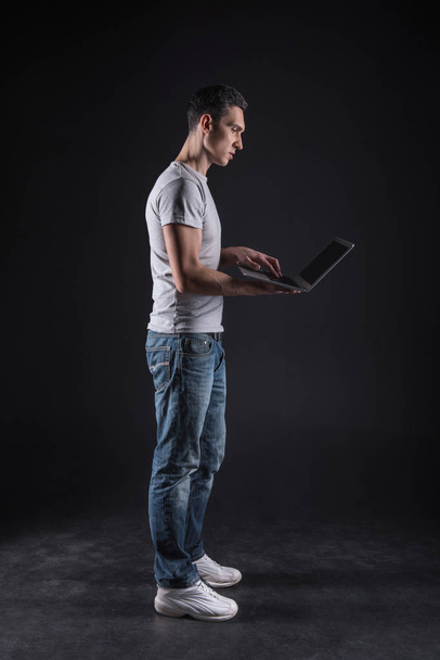 Pleasant intelligent man standing with a laptop - Photo, image