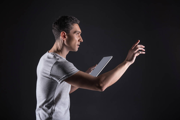 Confident handsome man working with digital devices - Фото, изображение