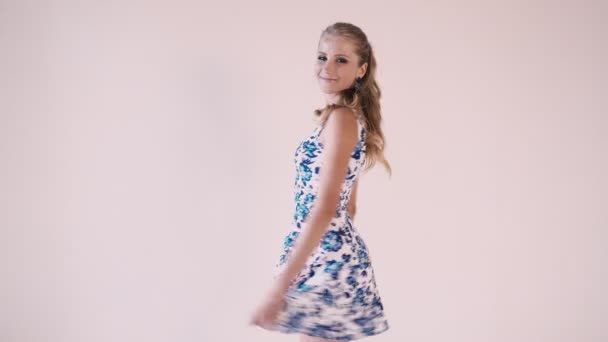 beautiful girl in a summer dress in white room - Filmati, video