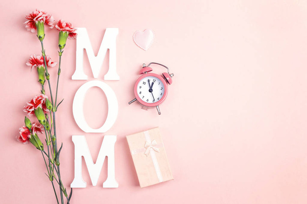 Mother's Day background with carnations flowers, alarm clock and - Zdjęcie, obraz