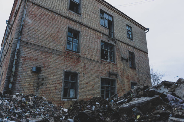 Abandoned ruined factory buildings with pile of rubbish, demolition and disaster concept - Photo, Image