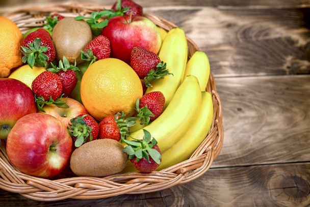 Gyümölcsök képviseltetik magukat az egészséges táplálkozás - finom és lédús gyümölcs egy fonott kosár kosárban - Fotó, kép