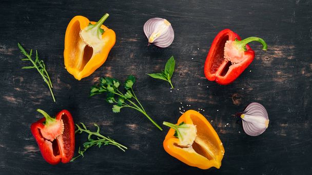 Fresh Bulgarian pepper. Paprika. On a wooden background. Top view. Copy space. - 写真・画像