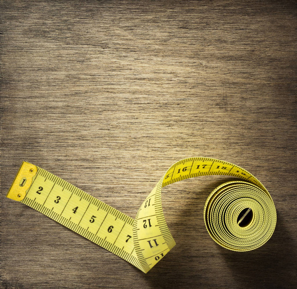 measuring tape on wooden background - Foto, immagini
