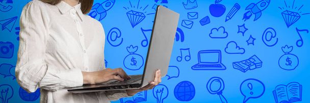 Girl with laptop in hands on a blue background with icons - Photo, Image
