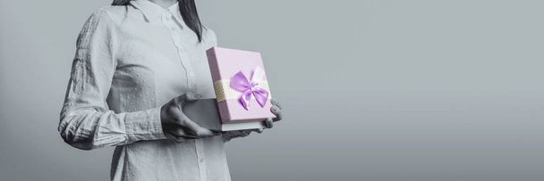 Молода дівчина відкриває перед собою подарункову коробку. Обличчя пояса
 - Фото, зображення