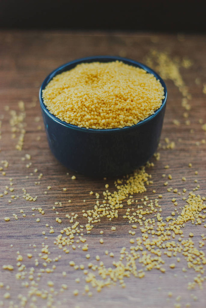 Raw couscous in the bowl - Foto, imagen