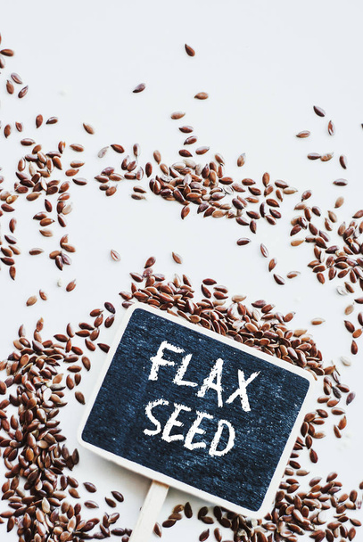 brown flaxseed or linseed and chalkboard with phrase flax seed - Photo, Image