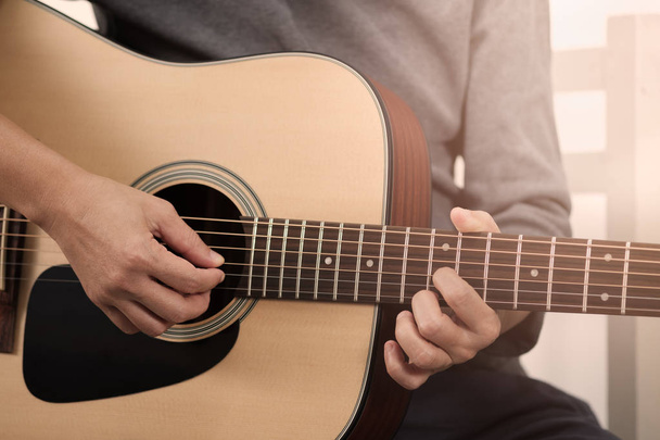 Woman's hands playing acoustic guitar. - Fotografie, Obrázek