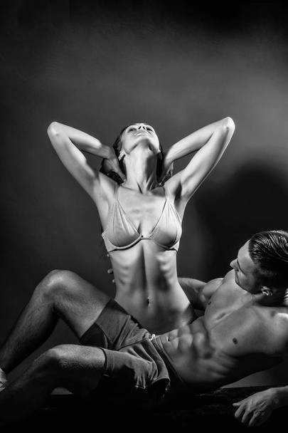Prelude - couple in love. Woman in beige bra with wet hair and handsome macho man with muscular torso and athletic body in studio. - Foto, immagini