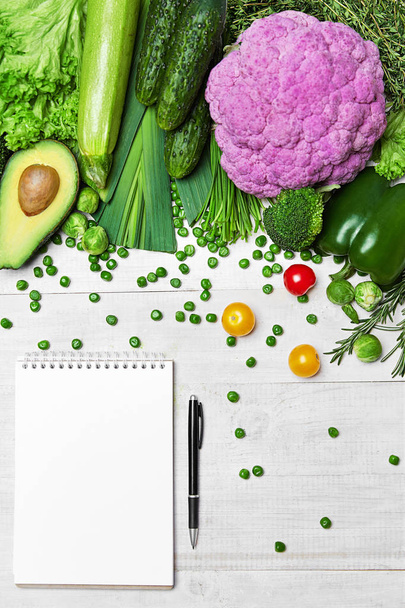 Shopping List. Green Vegetables And Notebook On Table - Foto, Bild