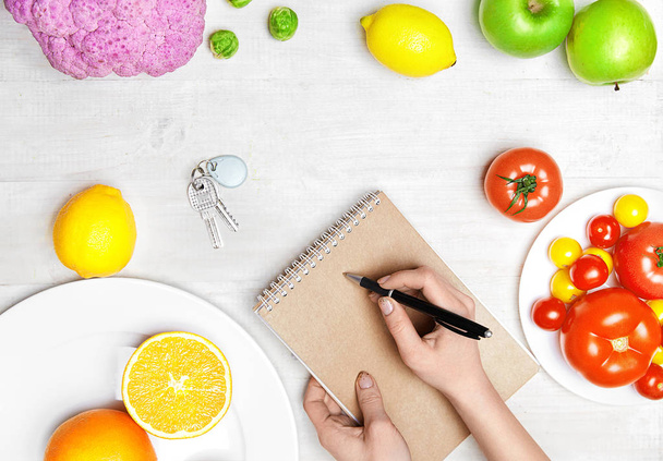 Healthy Food. Woman Hand Writing Diet Plan - Zdjęcie, obraz