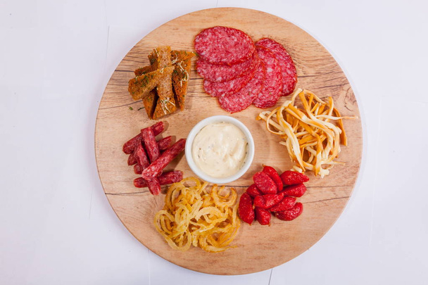 Plate with snacks and white beer sauce - Photo, Image