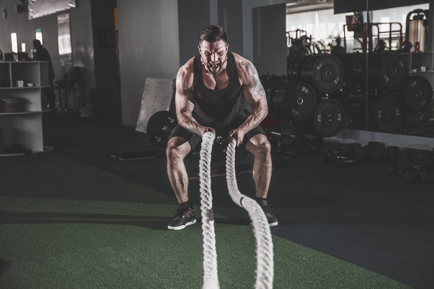 Men with rope in functional training fitness - Foto, Bild