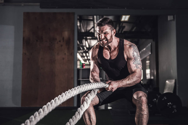 Men with rope in functional training fitness - Foto, Imagen