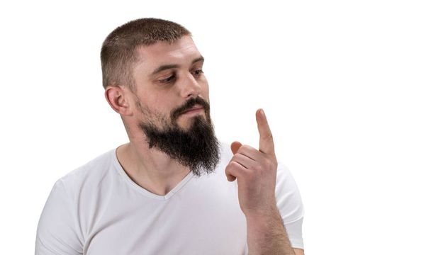 man looking at his index finger on white background with copy sp - Photo, Image
