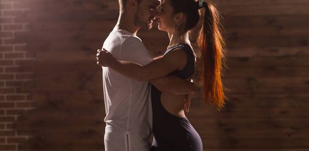 Young couple dancing latin dance Bachata, merengue, salsa. Two elegance pose in dance class - Photo, Image