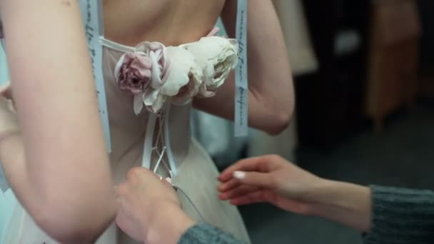 Stylist Helps to Tighten the Corset of a Historical Dress on Woman. Back View - Footage, Video