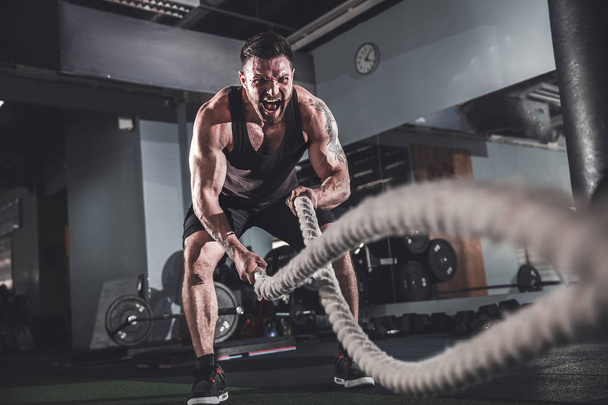 Men with rope in functional training fitness - 写真・画像