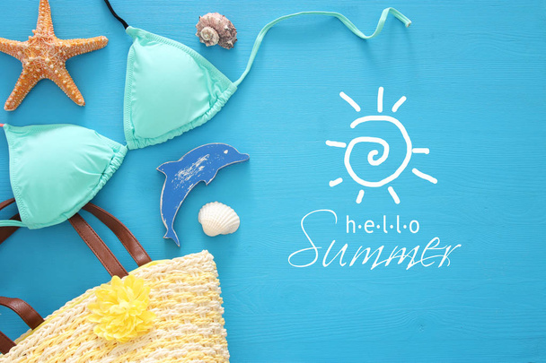 vacation and summer image with sea life style objects and mint bikini over blue wooden background. - Фото, изображение