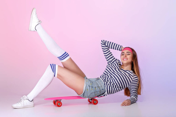 beautiful woman with skate in studio - Foto, Imagem