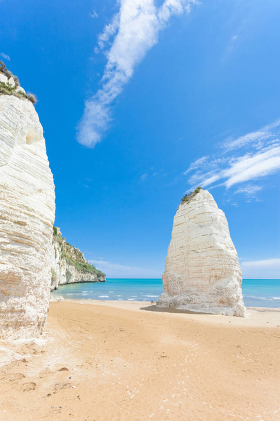 Vieste, Italy - Huge chalk cliffs at the beach of Vieste - Photo, Image