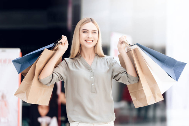 Happy blonde with shopping bags at mall. Sale. - Foto, Imagem