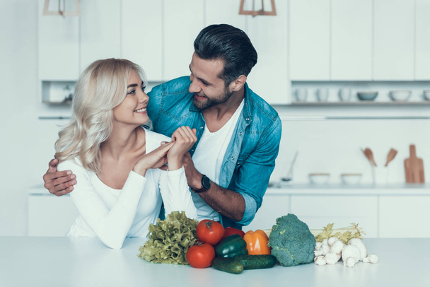 Happy couple preparing breakfast together in kitchen. - Photo, Image