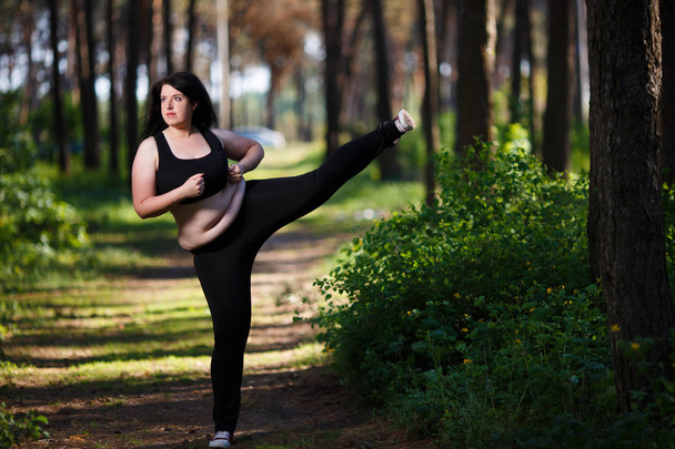 junge übergewichtige Frau trainiert im Park - Foto, Bild