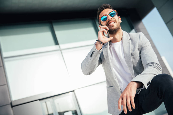 View of a Young attractive business man using smartphone - Foto, imagen