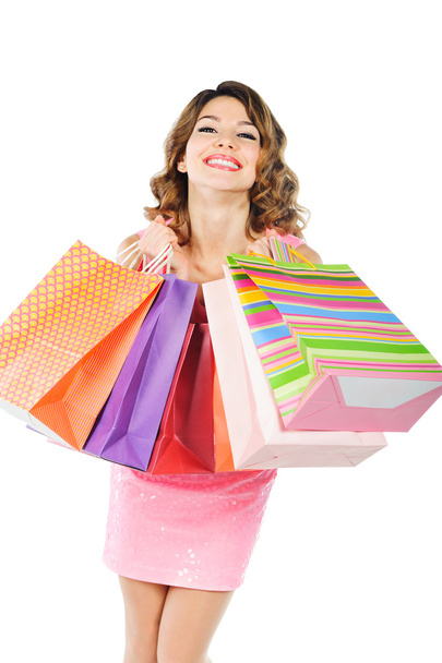 Young cheerful girl with shopping bags isolated on white - Фото, зображення