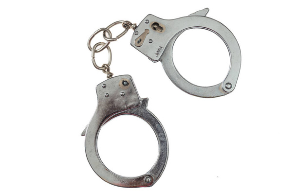 Металлические наручники изолированы на белом фоне, вид сверху
 - Фото, изображение
