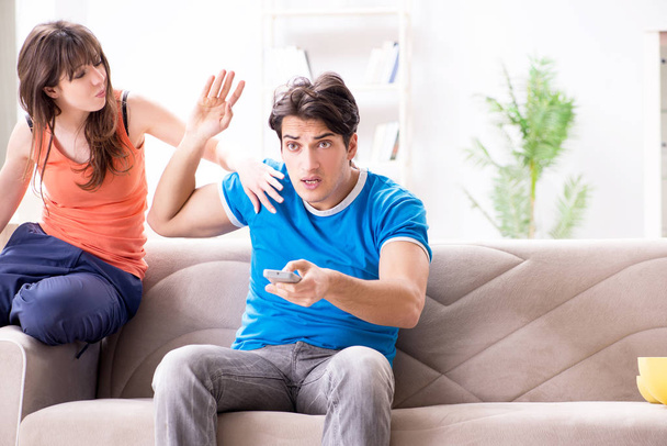 Wife unhappy that husband is watching football - Photo, Image