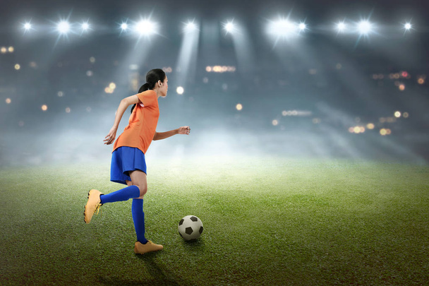 Young soccer player kicking ball - Фото, изображение