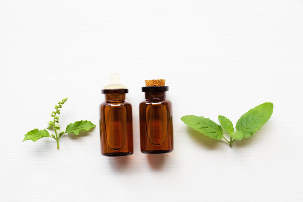 Holy basil essential oil with leaves. - Photo, Image