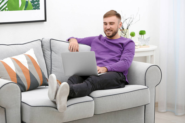 Young man with modern laptop  - Фото, зображення