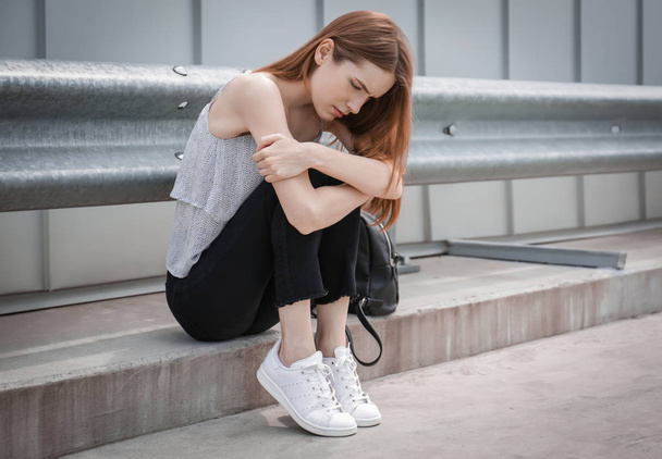 Depressed young woman, outdoors - 写真・画像