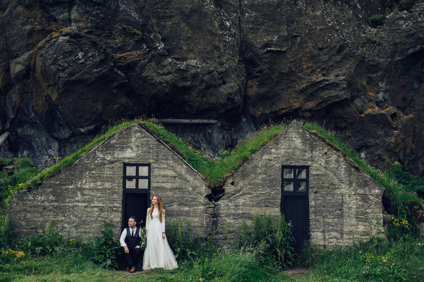 married couple posing on traditional stone houses background - 写真・画像