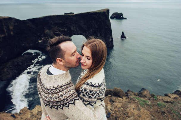 portrait of married couple in sweaters posing on seascape background - Foto, Imagen