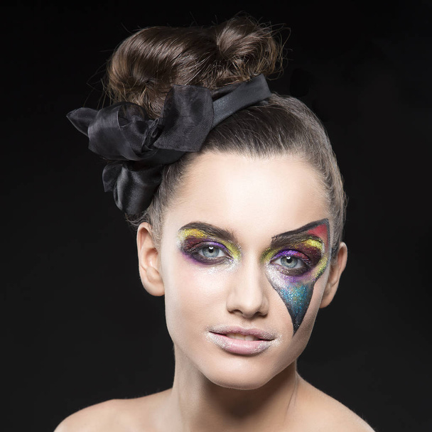 portrait of young woman with extraordinary makeup on black background - Foto, Imagen