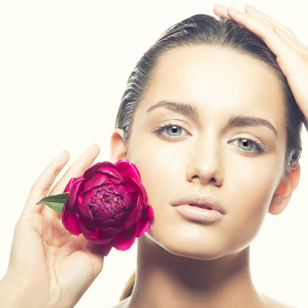 Portré, fiatal nő természetes smink és a pünkösdi rózsa virág, fehér háttér - Fotó, kép