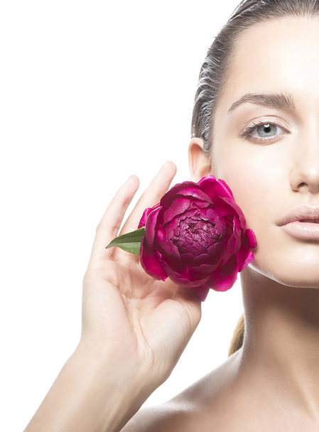 Cropped portrait of young woman with natural makeup and peony flower on white background - Foto, afbeelding